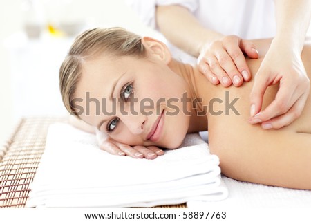 Smiling caucasian woman receiving an acupuncture treatment in a health spa