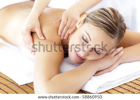 Relaxed smiling woman receiving a back massage in a spa
