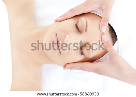 stock photo Caucasian young woman receiving a facial massage in a health 