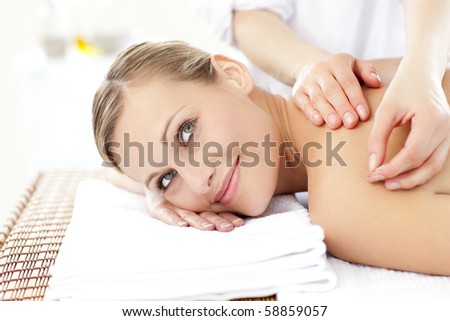 Smiling blond woman receiving an acupuncture treatment in a health spa