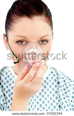 Diseased young woman with an oxygen mask looking at the camera against white background