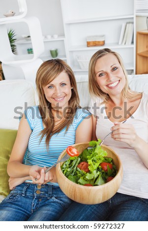Animated women eating a salad in the living-room