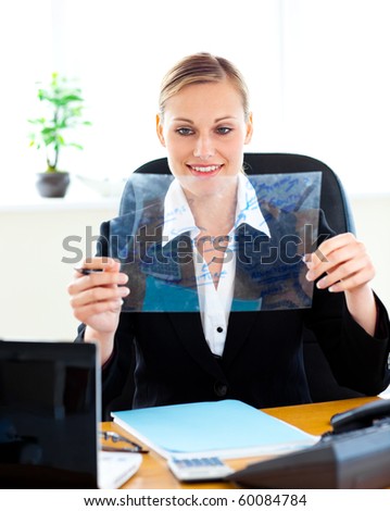 Serious businesswoman preparing a presentation at her desk in her office