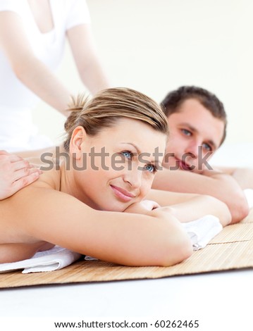 Attractive young couple receiving a back massage in a spa center