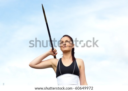 Female athlete throwing the javelin outdoors
