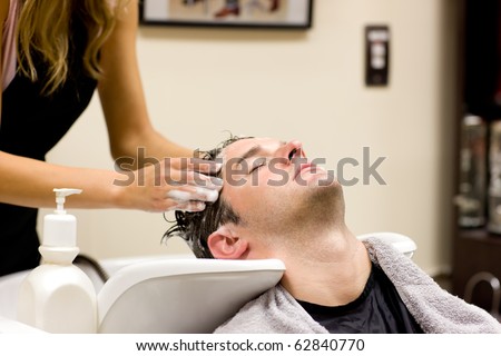 Attractive man having a shampoo in a hairdressing salon