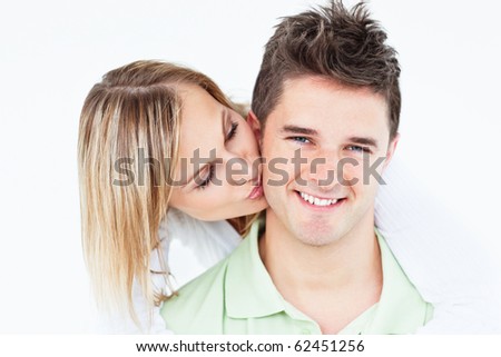 stock photo : Happy smiling couple in love woman kissing her boyfriend over white background