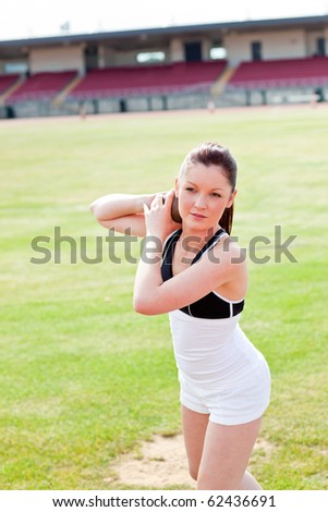 Attractive athletic woman during a shot put training in a stadium