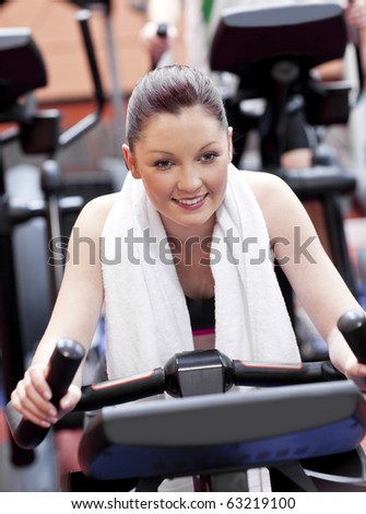 Portrait of a positive woman doing exercises in a sport centre