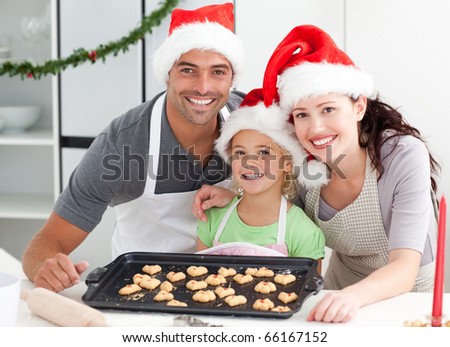 Happy woman with husband and daughter ith their biscuits ready to eat in the kitchen