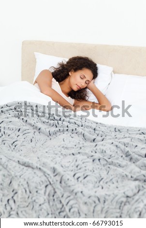Beautiful woman sleeping peacefully on her bed in the morning at home