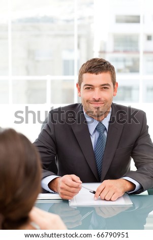 Happy businessman during an interview with a female colleague at the office