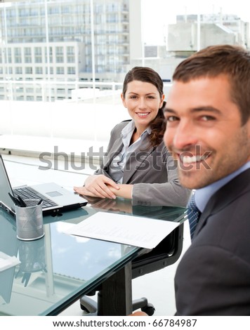 Two positive business people smiling at the camera during an interview