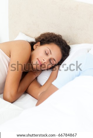 Pretty woman sleeping peacefully on her bed in the morning at home