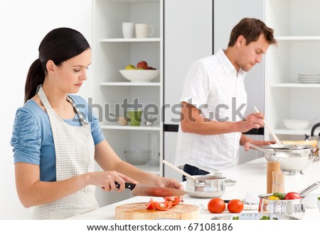 Couple cooking together their lunch in the kitchen