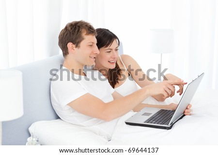 Young pairs watching videos on their computer at home