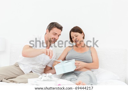 Woman offering a gift to her wife at home