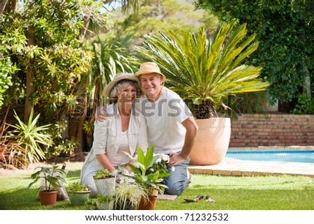 Senior couple looking at the camera in the garden