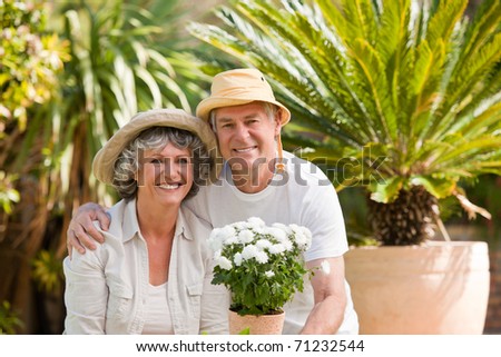 Senior couple looking at the camera in the garden