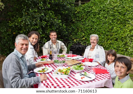 Happy family eating in the garden