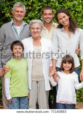 Portrait of a happy family looking at the camera in the garden