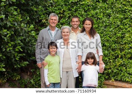 Portrait of a happy family looking at the camera in the garden