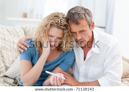 Lovers looking at a pregnancy test at home