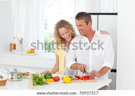 Couple cooking together in their kitchen at home