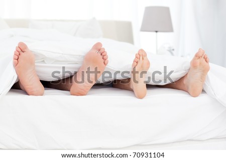 Couple\'s feet in the bed