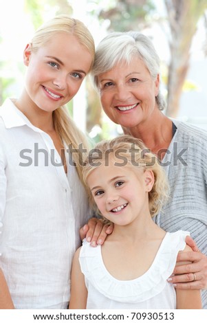 Portrait of a joyful family looking at the camera at home
