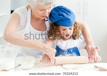 A little girl  baking with her grandmother at home