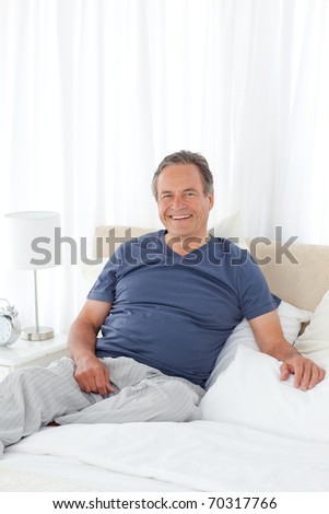 Man  lying down on his bed at home