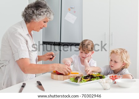 Children cooking with their grandmother at home