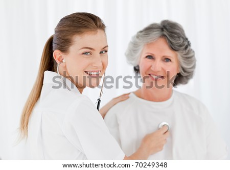 Retired patient with her nurse looking at the camera