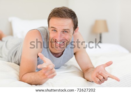Man lying down on his bed