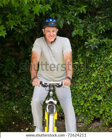 Mature man mountain biking outside