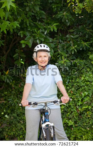 Mature woman mountain biking outside
