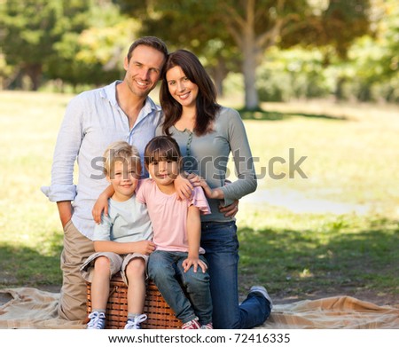 Smiling family picnicking in the park