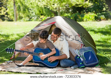 Father playing guitar with his son
