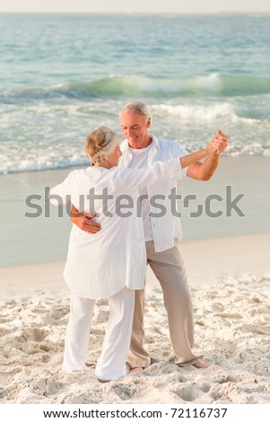 Elderly couple dancing on the beach