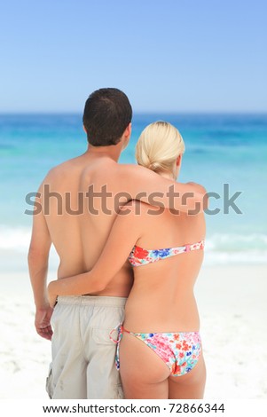 Woman hugging her husband on the beach