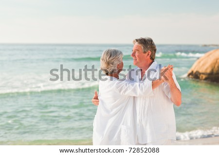 Elderly couple dancing on the beach