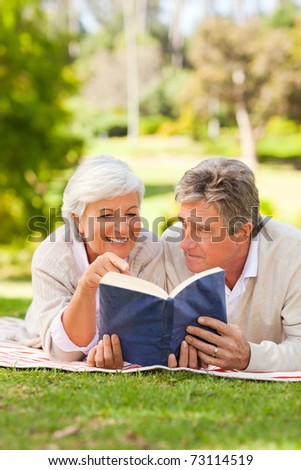 Couple reading a book in the park
