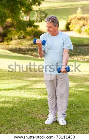 Elderly man doing his exercises in the park