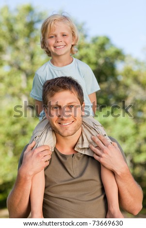 Happy father giving son a piggyback