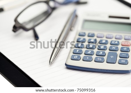 Note pad, pen, glasses and pocket calculator on a white background