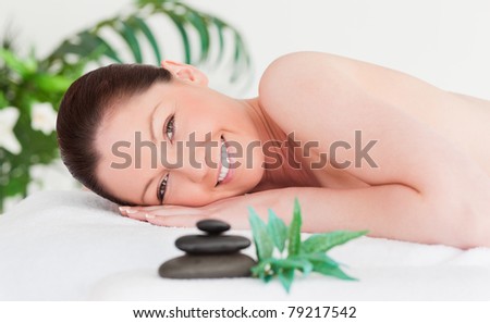 Happy young woman lying on her belly in a spa