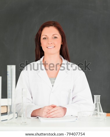 Smiling scientist looking at the camera in a classroom