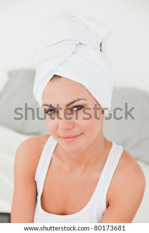 Portrait of a woman with the hair wrapped into a towel in studio