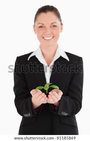 http://image.shutterstock.com/display_pic_with_logo/76219/76219,1310996101,108/stock-photo-beautiful-woman-in-suit-holding-a-small-plant-while-standing-against-a-white-background-81185869.jpg